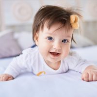 The small baby lies on the bed