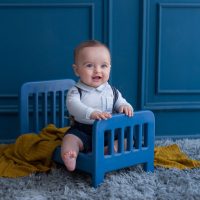toddler-with-elegant-outfist-inside-decorative-bed-room